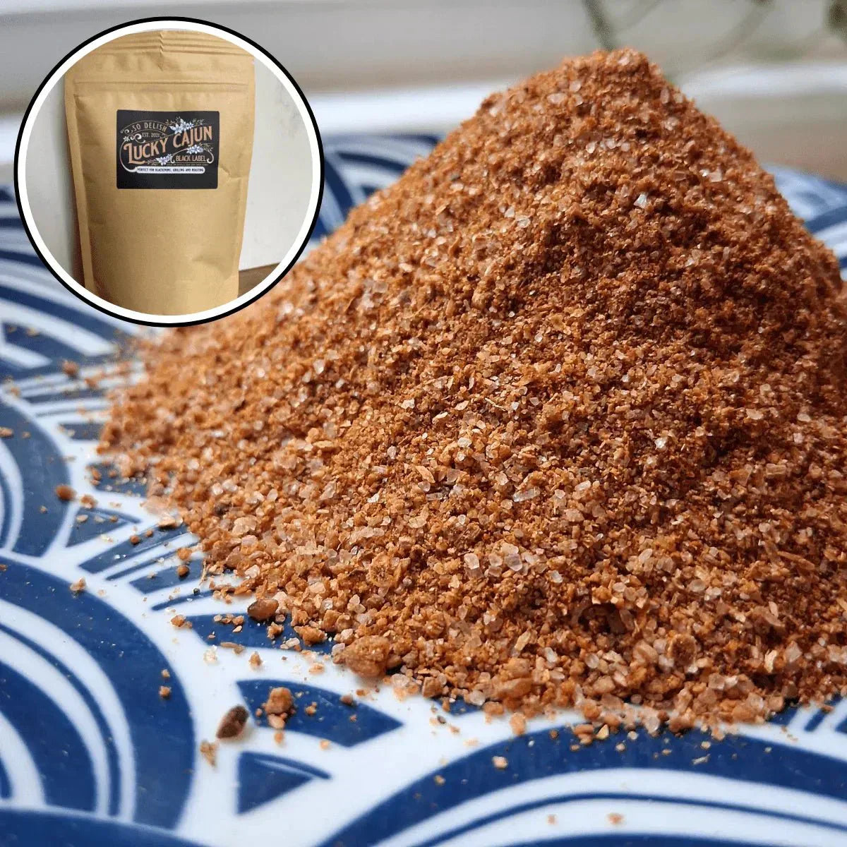 Close up pile of fresh ground Lucky Cajun seasoning showing vibrant color and texture of small batch weekly ground Cajun spice blend with Born-On Date guarantee