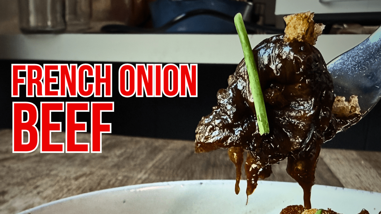 French onion beef tutorial thumbnail showing tender braised beef with deep golden onions and melted Gruyère cheese over creamy mashed potatoes made with Lucky Cajun Black Label seasoning