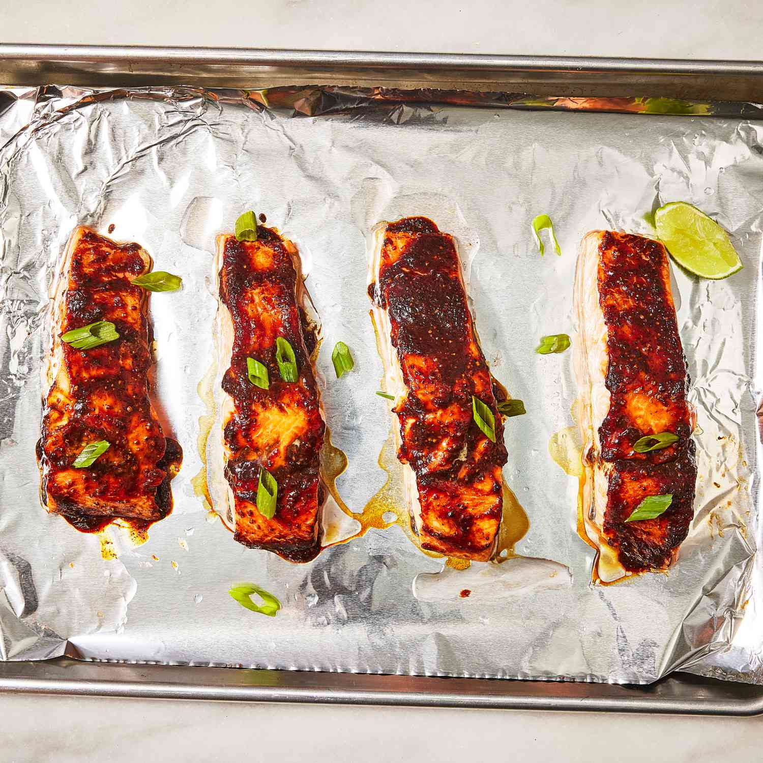 Miso glazed salmon roasted on a pan showing the glossy lacquered coating that develops when the miso honey and sake marinade reduces during baking at 375°F