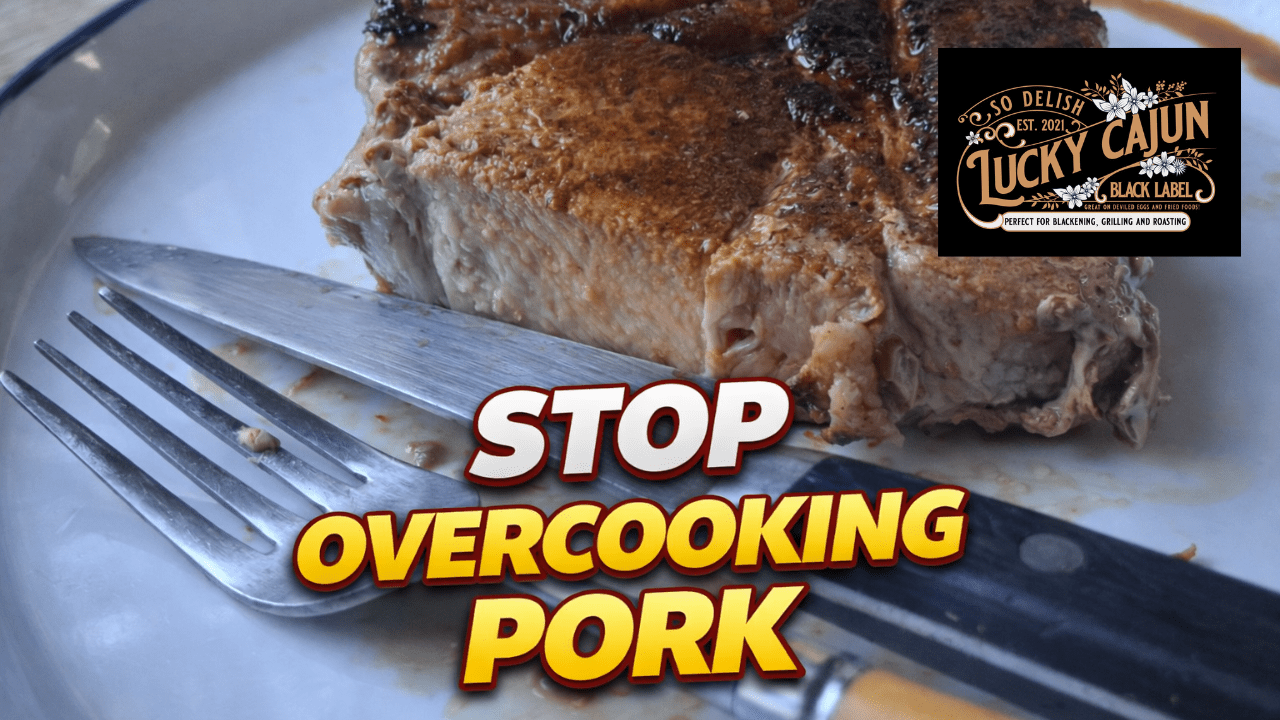 Thick-cut pork chop sliced open with a knife and fork showing a juicy pink center, cooked in cast iron with Lucky Cajun Blackened Scorpion seasoning.