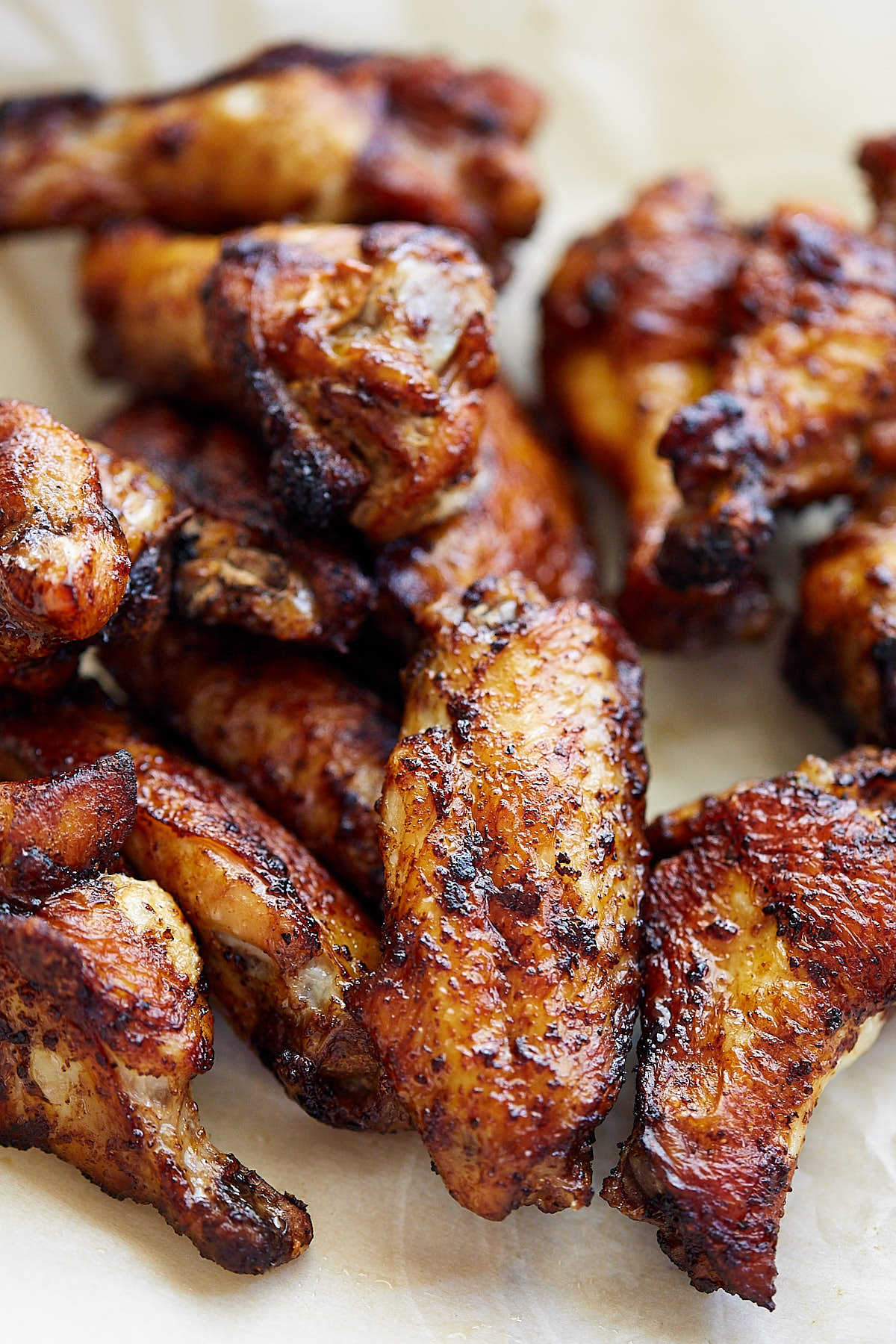 Close-up of slow-roasted Voodoo wings with a crispy golden skin, seasoned with Lucky Cajun Voodoo fresh-ground habanero blend and baked fall-off-the-bone tender.