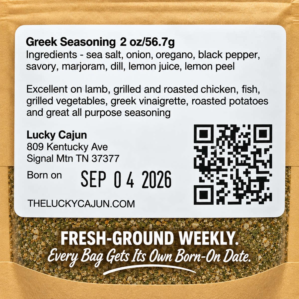 A close-up of a seasoning packet label reading 'Greek Seasoning 2 oz/56.7g' with ingredients listed, a QR code, and Lucky Cajun branding on a kraft paper package.
