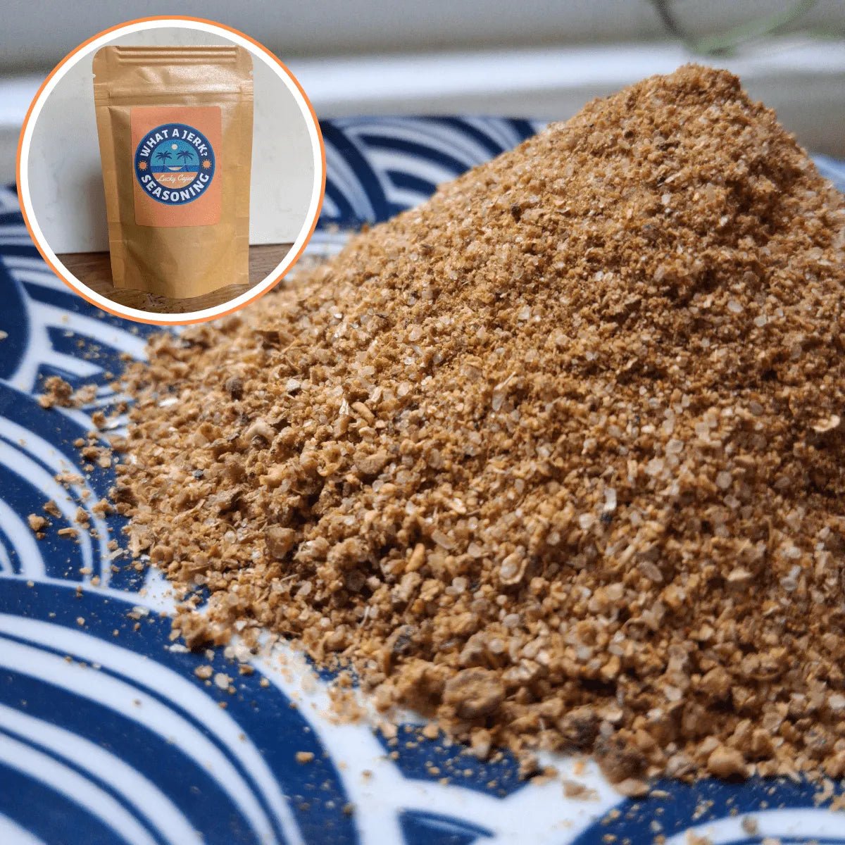 Close-up of fresh-ground What A Jerk? seasoning piled on a plate with product packaging, showing the coarse texture of the sugar-free spices.