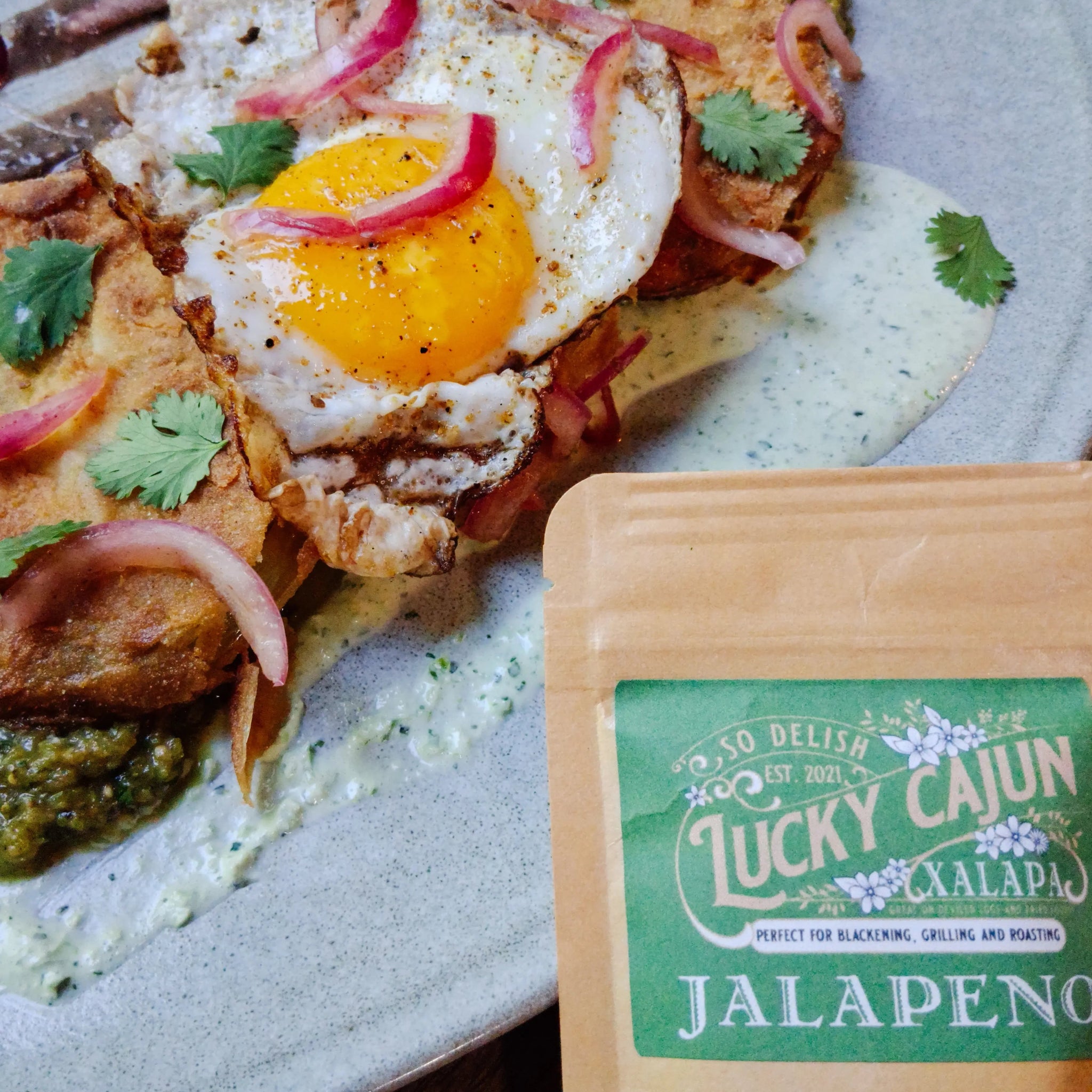 Lucky Cajun Xalapa Jalapeño Seasoning served with crispy fried green tomatoes and perfectly fried eggs—a 'Full Color' Southern breakfast that beats the Flavor Ghosts.