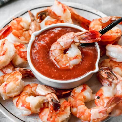Classic shrimp cocktail with cocktail sauce in a bowl surrounded by chilled shrimp showing the sharp contrast sauce built on ketchup horseradish and Lucky Cajun Fiery Datil seasoning