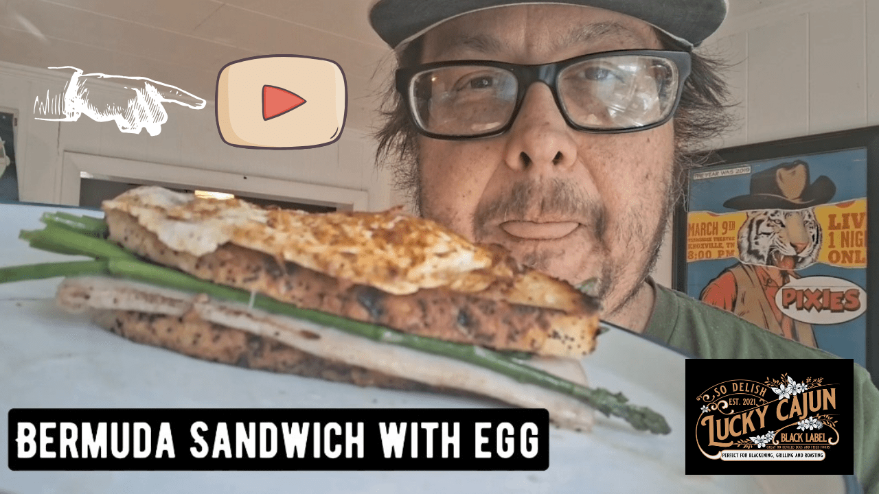 Hot ham and cheese sandwich with melted Swiss asparagus and a fresh ground Lucky Cajun Voodoo seasoned over-easy egg on butter-toasted sourdough