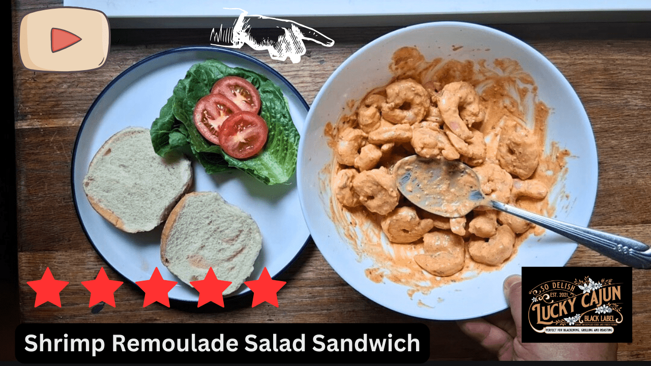 Bowl of Cajun shrimp salad dressed in Sneaky Sauce remoulade with a soft bun, lettuce and tomato unassembled on a white plate — made with Lucky Cajun Black Label seasoning.