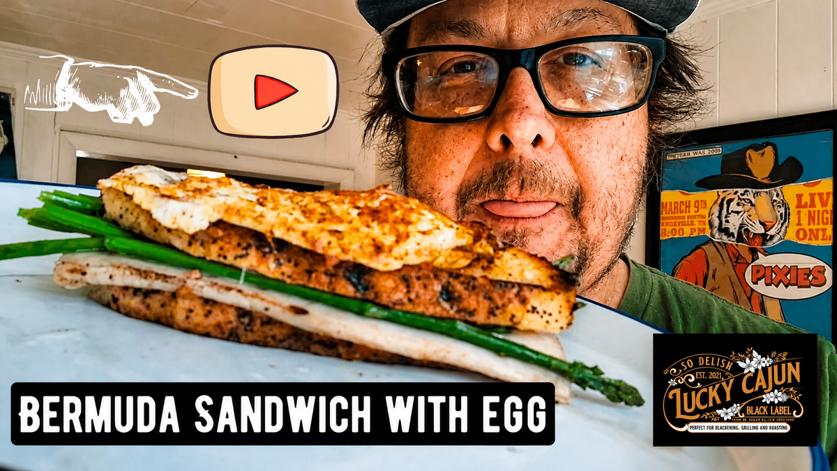 Hot ham and cheese sandwich with melted Swiss asparagus and a fresh ground Lucky Cajun Voodoo seasoned over-easy egg on butter-toasted sourdough