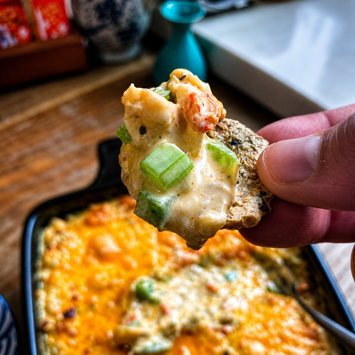 Crawfish artichoke dip on a cracker made with lucky cajun seasoning