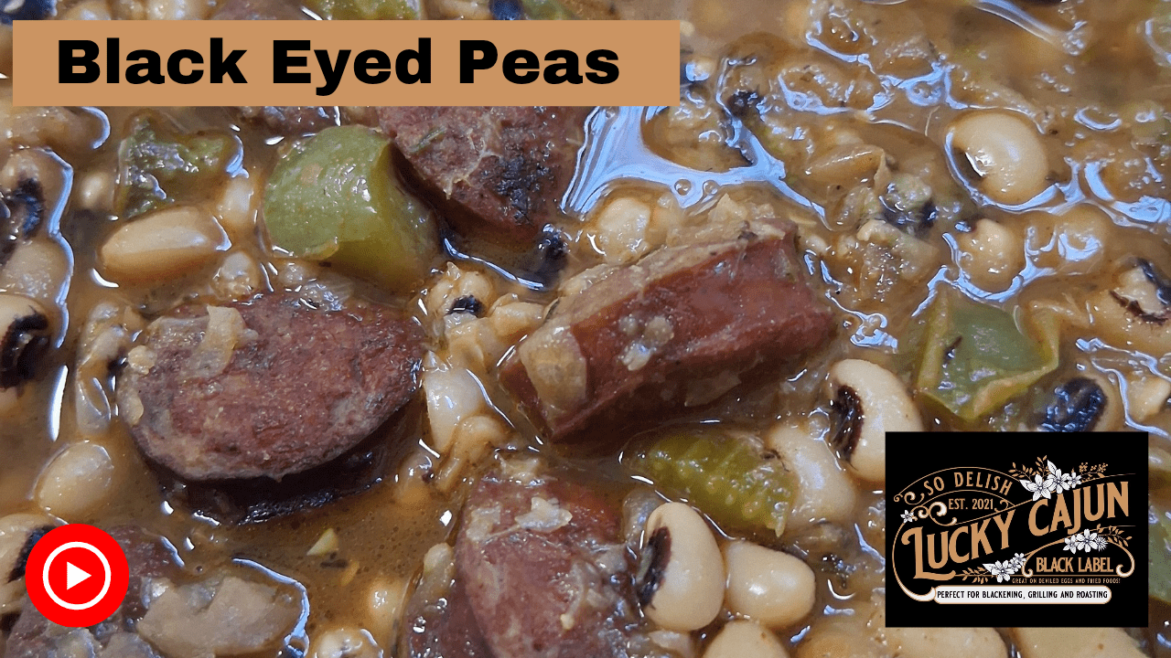 Close-up of Southern black-eyed peas and andouille sausage simmered with bell pepper and onions in a rich creamy Cajun stew, seasoned with Lucky Cajun Black Label.