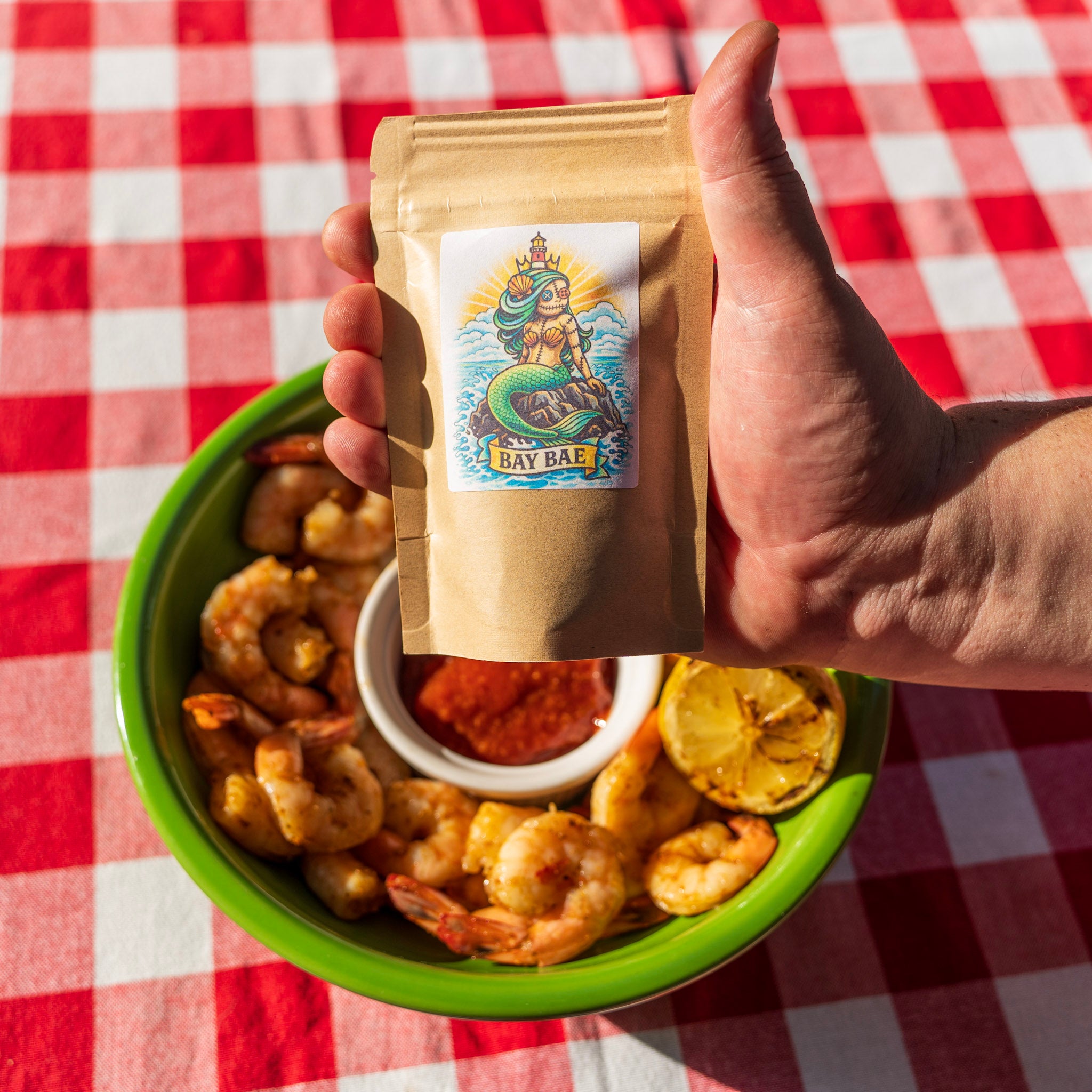 Poached shrimp with cocktail sauce, grilled lemon and Bay Bae seafood seasoning bag — Lucky Cajun