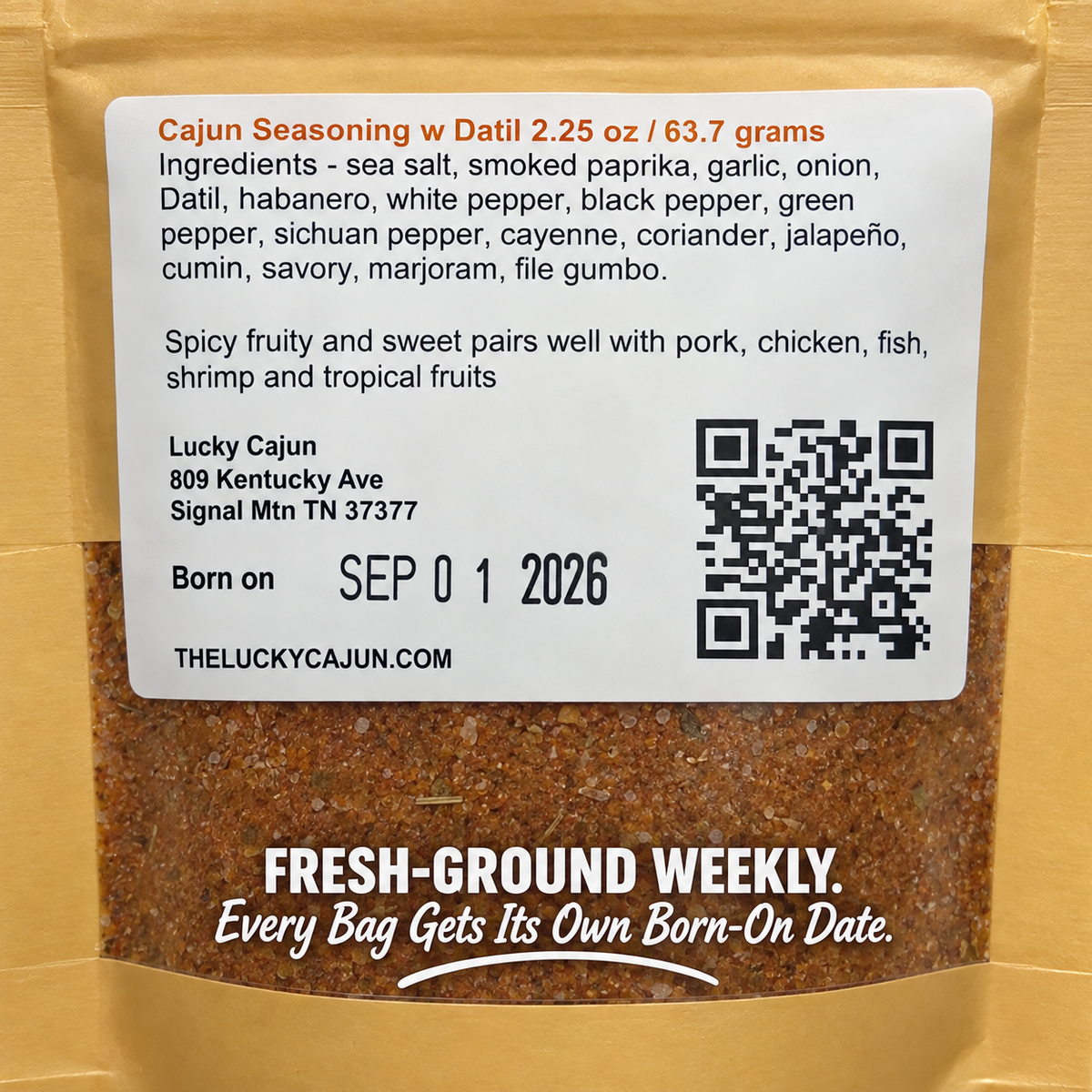 A bag of Lucky Cajun Seasoning with Datil, showing the front of the kraft paper packaging with a large white ingredient label and the ground spice visible through the clear lower section.