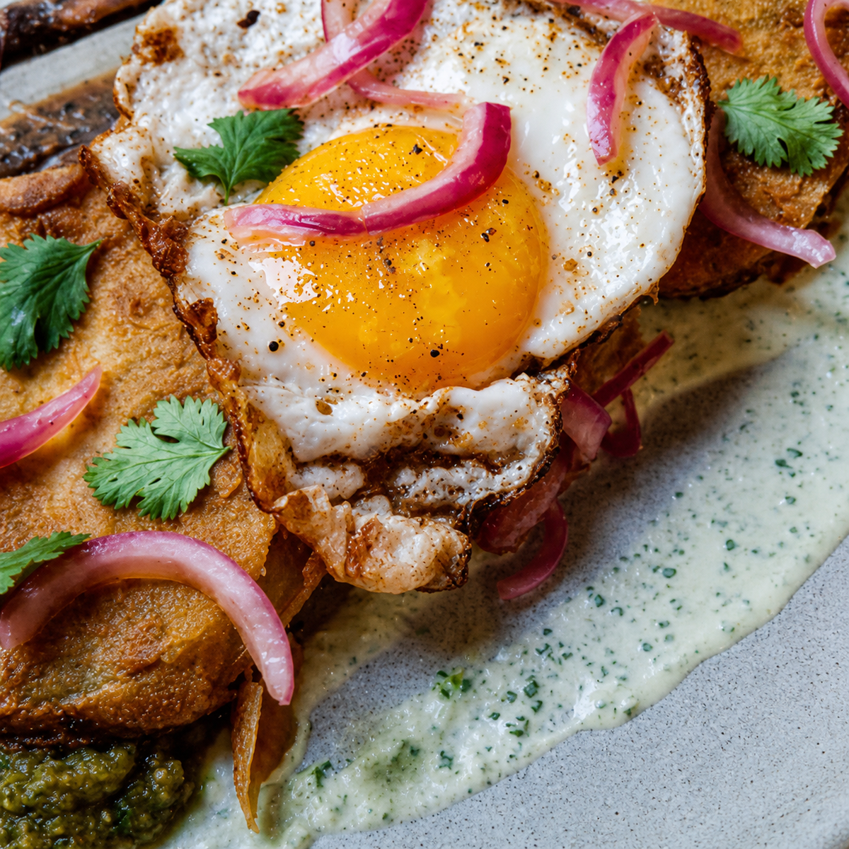 Lucky Cajun Xalapa Jalapeño Seasoning served with crispy fried green tomatoes and perfectly fried eggs—a 'Full Color' Southern breakfast that beats the Flavor Ghosts.