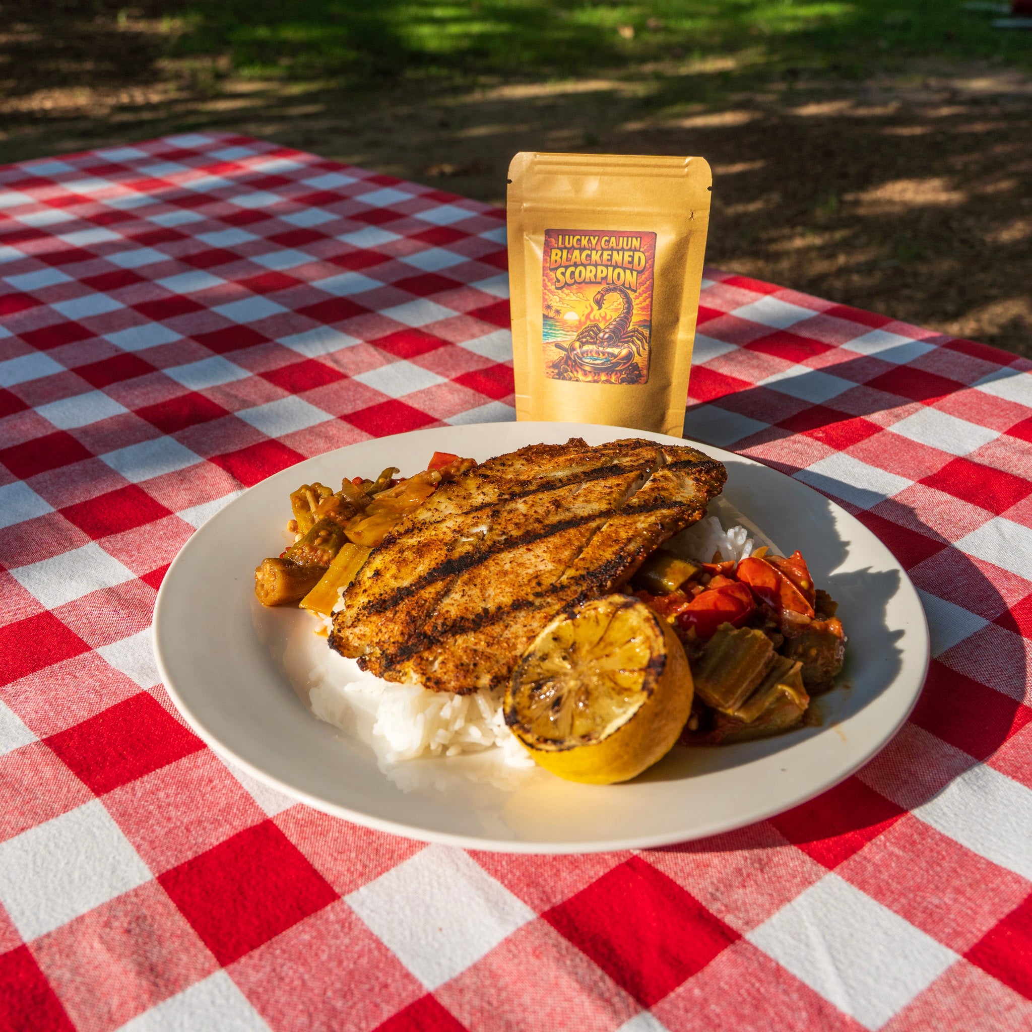 Grilled catfish with tomato okra rice and charred lemon seasoned with Blackened Scorpion — Lucky Cajun