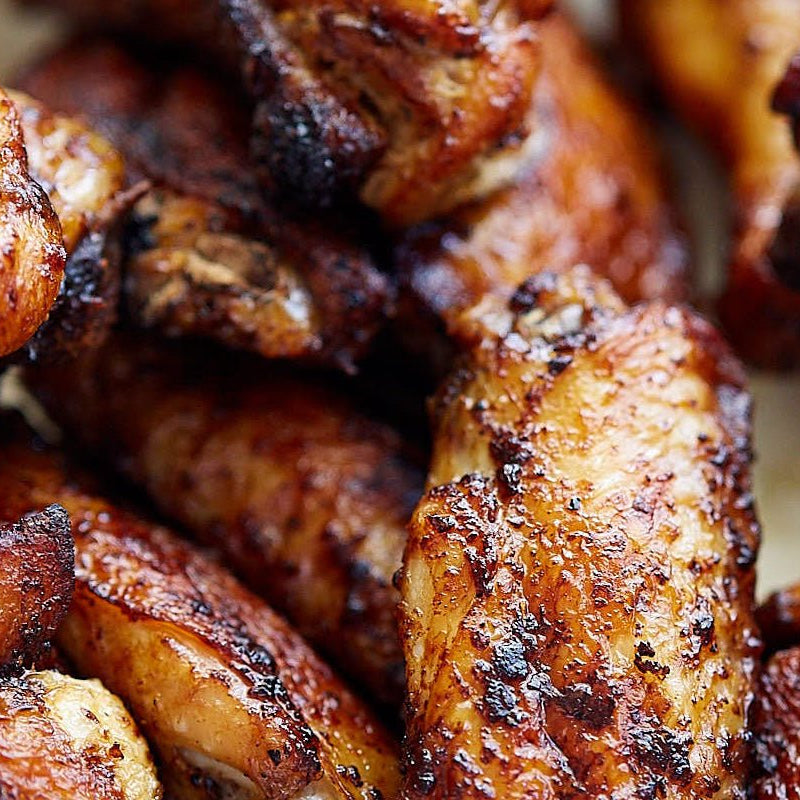 Close-up of air fryer chicken wings seasoned with What A Jerk? authentic jerk seasoning. 100% sugar-free and fresh-ground.