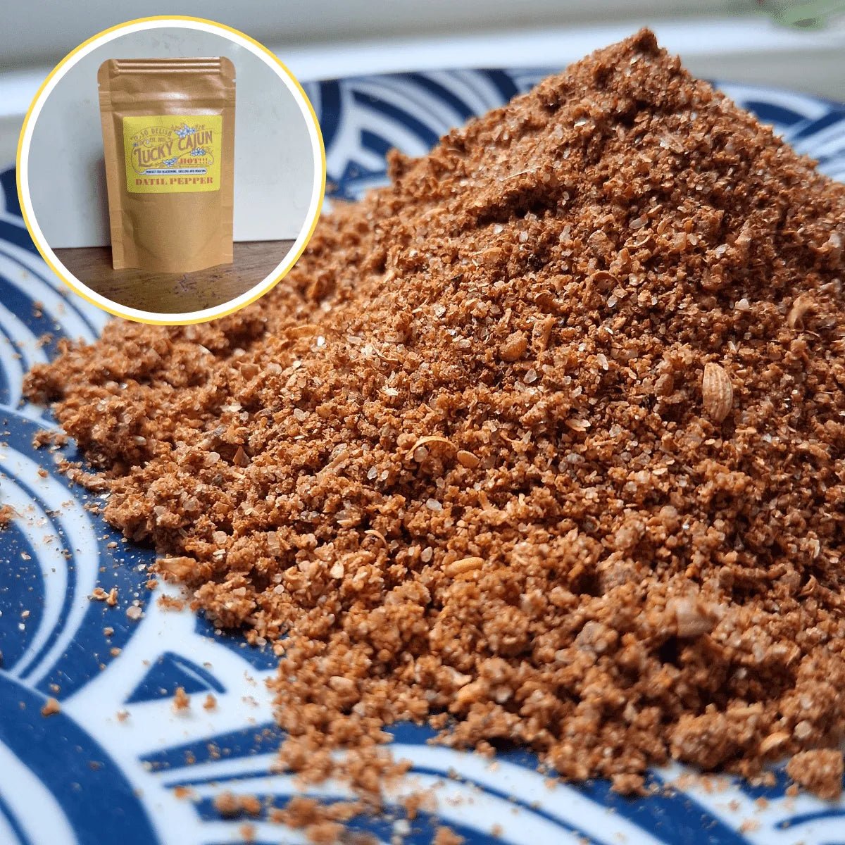 A close-up pile of Fiery Datil spice blend on a plate showing the coarse texture of fresh-ground Datil peppers, smoked paprika, and Sichuan peppercorns. No fillers or anti-caking agents.