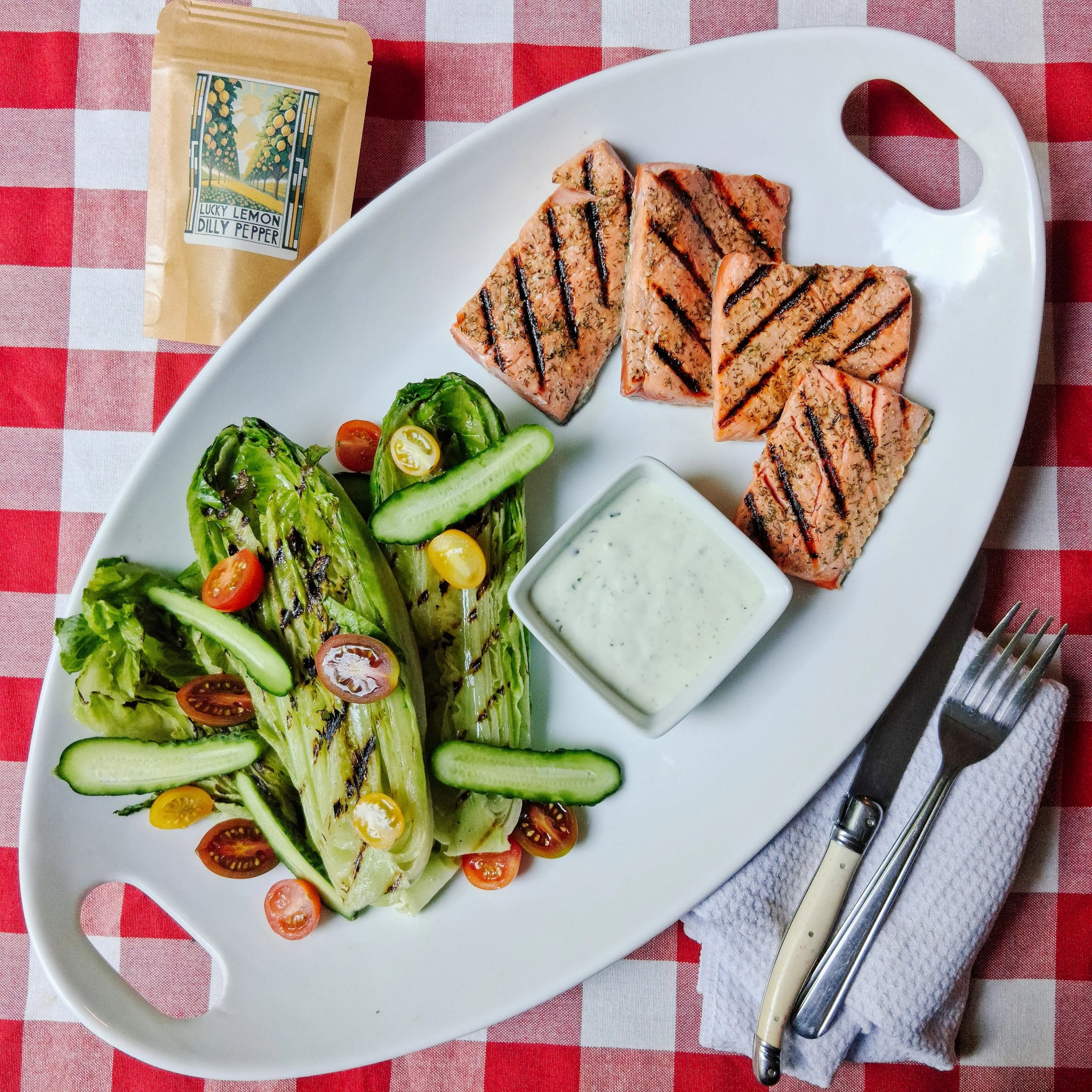 Perfectly seasoned grilled salmon and asparagus using Lucky Lemon Dilly Pepper, showing the bright, fresh herb crust without the spicy heat.