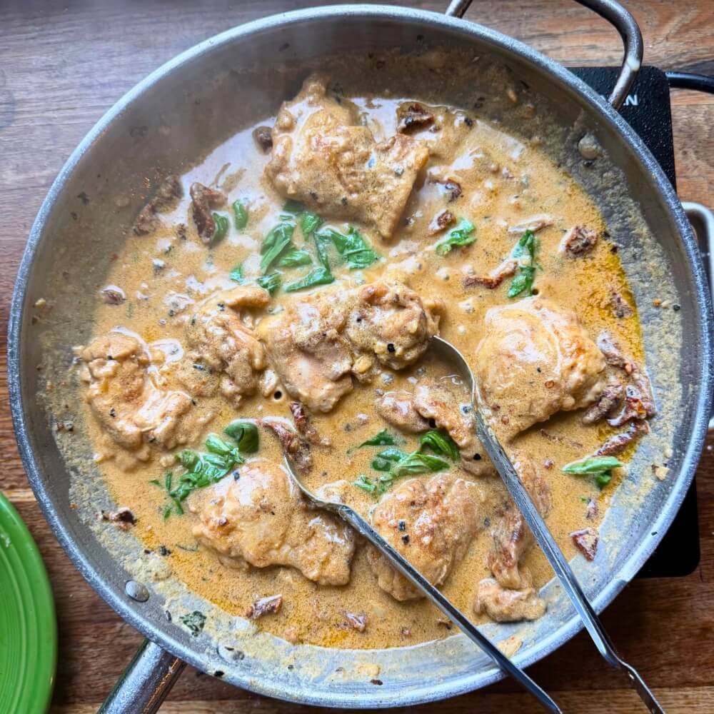 Marry Me Chicken cooking in a pan using Lucky Cajun fresh-ground, sugar-free seasoning.