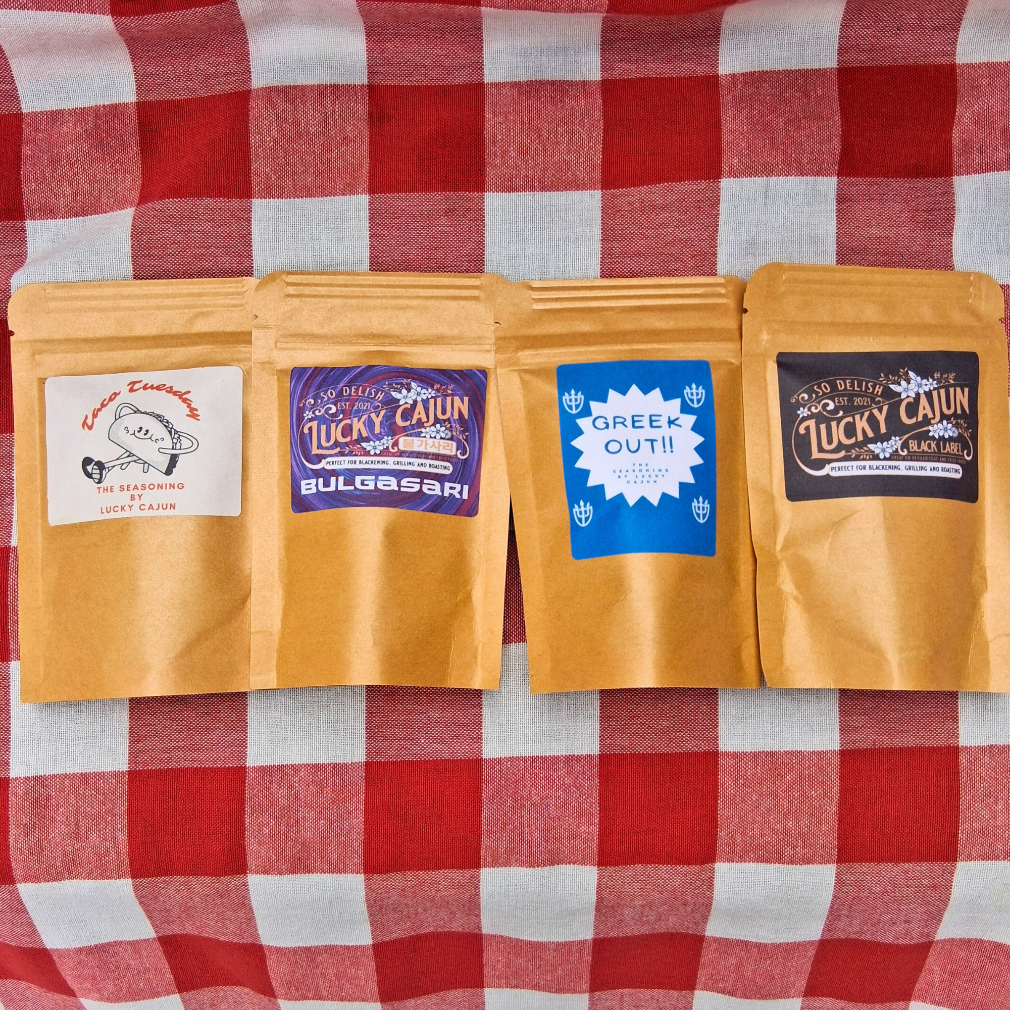 Old Seasoning Replacement Kit 4-pack of fresh-ground, sugar-free seasonings on a picnic tablecloth.
